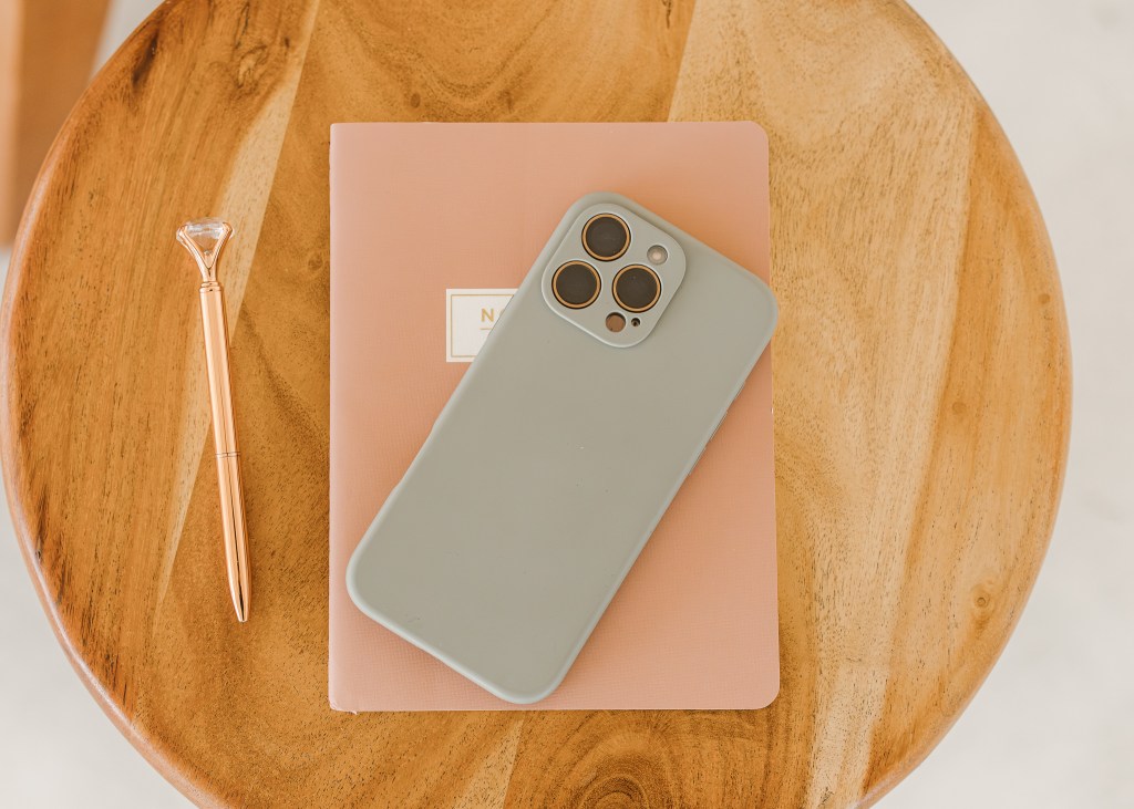 phone and notepad with pen on end table